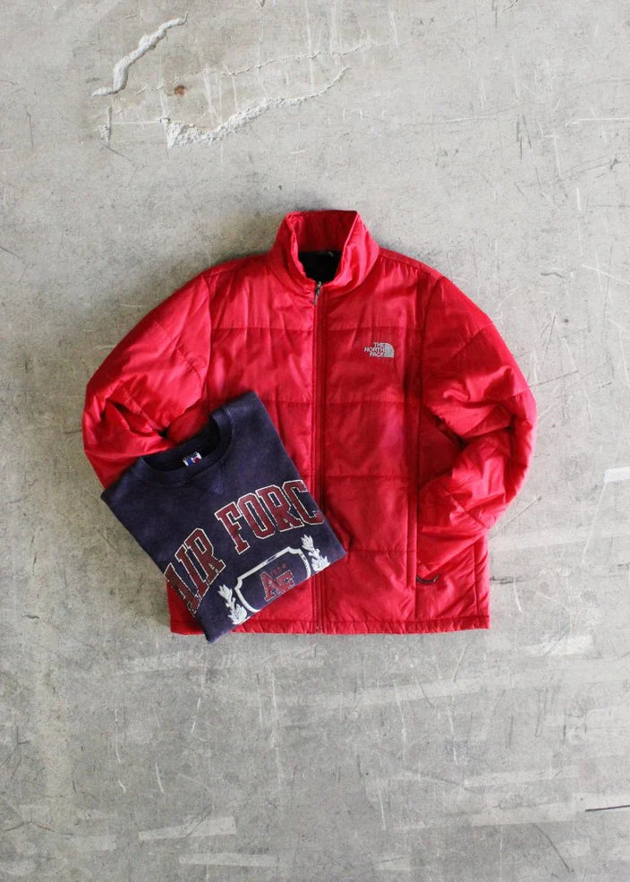 Authentic 1990s Made in USA Russell Air Force sweatshirt that has been acid washed for a unique look and comfortable feel, paired with a North Face puffer zip up jacket.